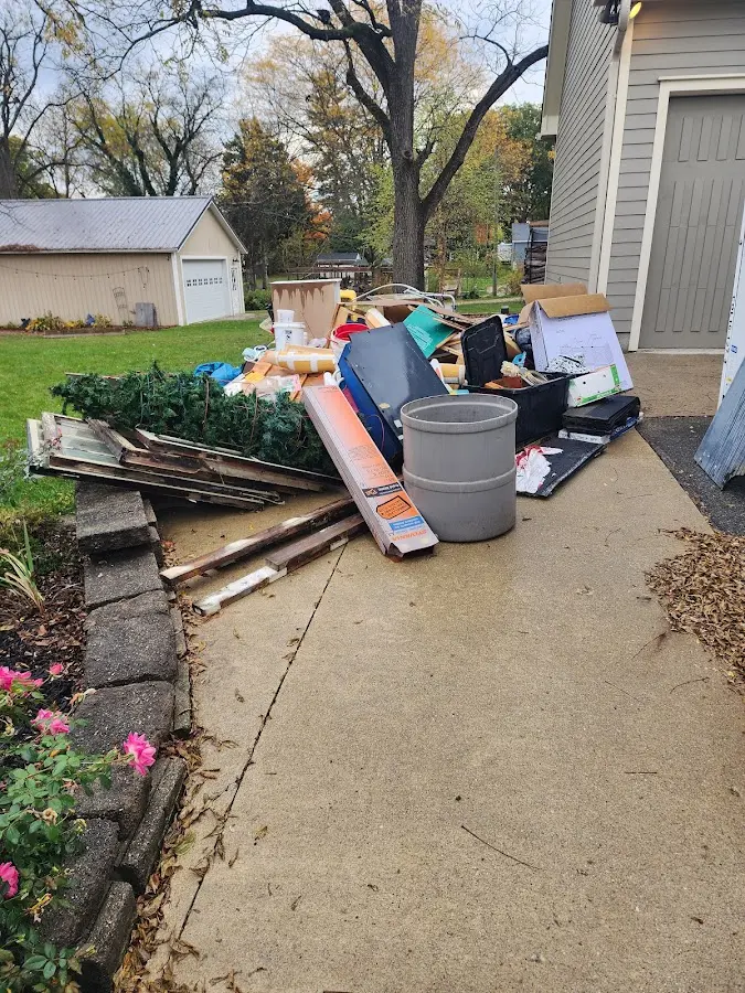Dumpster being loaded with debris for Estate Cleanout Dumpster Rental in Dundee